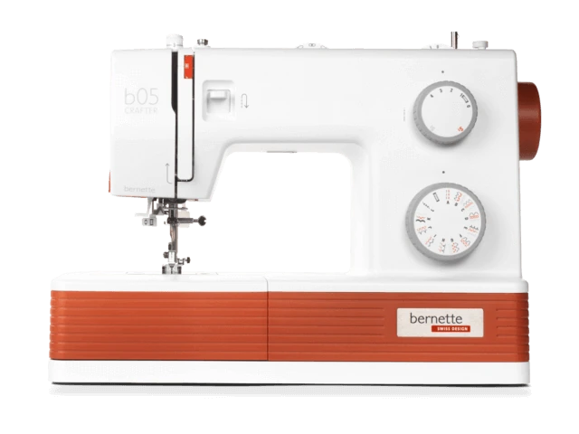 Official orange-and-white bernette 05 CRAFTER product image. Optional extension table and extra specialty feet are not shown as supplied items.