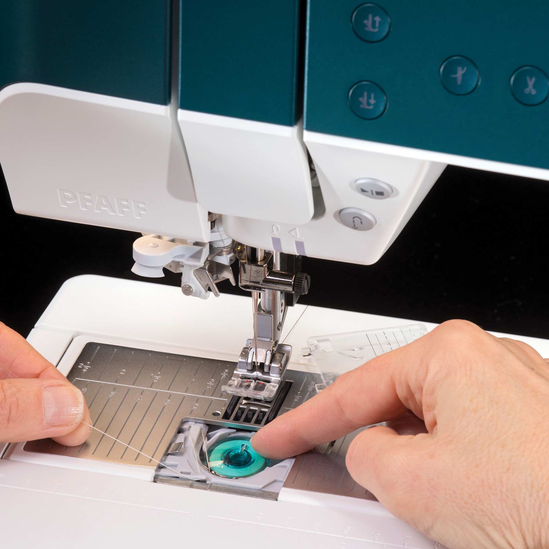 PFAFF performance icon sewing machine needle area, presser-foot assembly and teal-and-white casing.